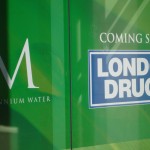 London Drugs at Millennium Water in the Olympic Village Green sign on windows of what will be the London Drugs at Millennium Water in the Olympic Village